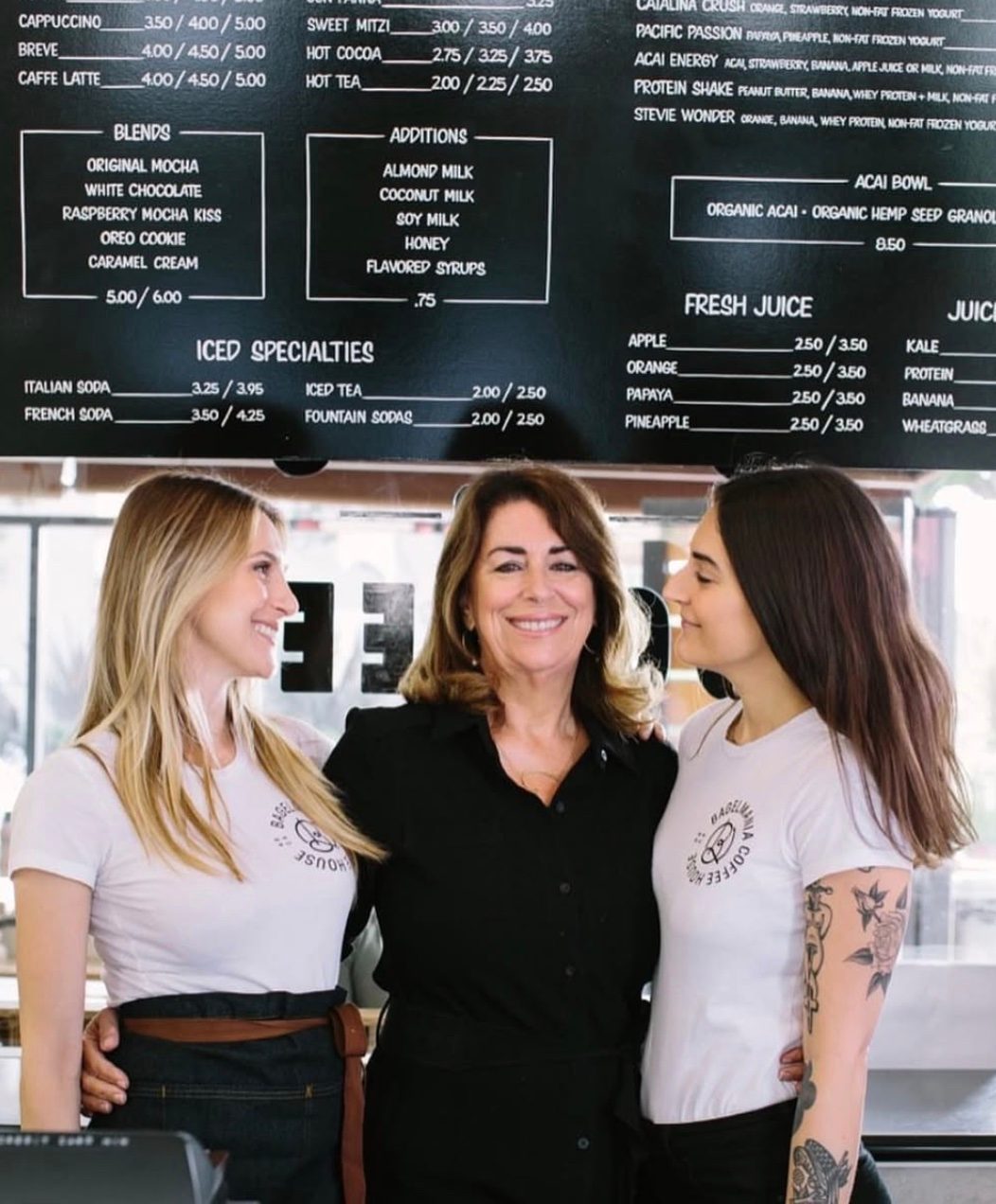 Christina with two Bagelmania staff members behind the counter